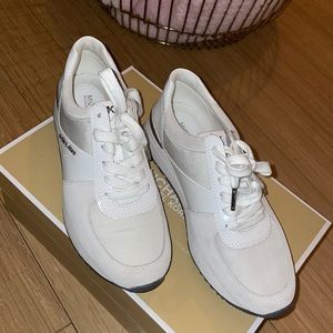 White and silver Michael Kors sneakers.